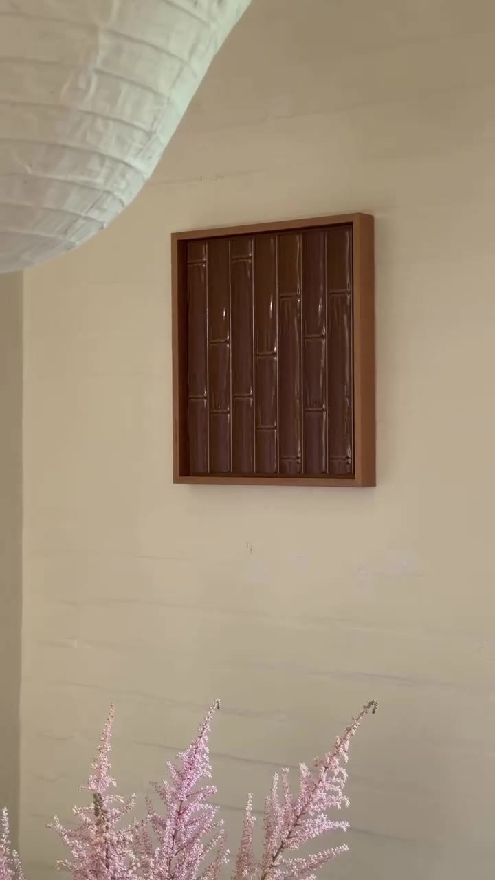 Close-up of the textured artwork in its wooden frame