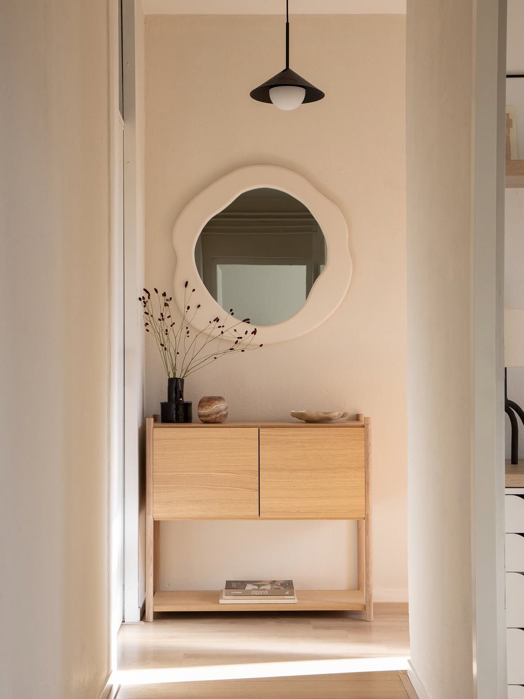 Minimal hallway with organic mirror
